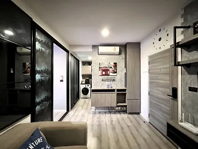 Modern living room with stylish decor and in-unit washing machine