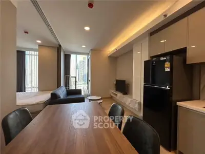 Modern open-plan living room with kitchen and city view balcony