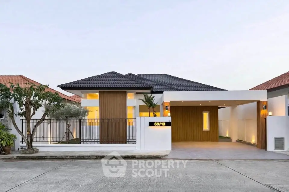 Modern single-story house with sleek design and spacious driveway