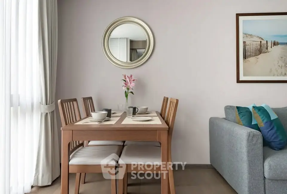 Elegant dining area with wooden table and chairs, cozy sofa, and stylish decor in a modern apartment.