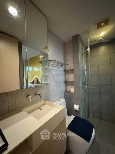 Modern bathroom with sleek fixtures and glass shower enclosure