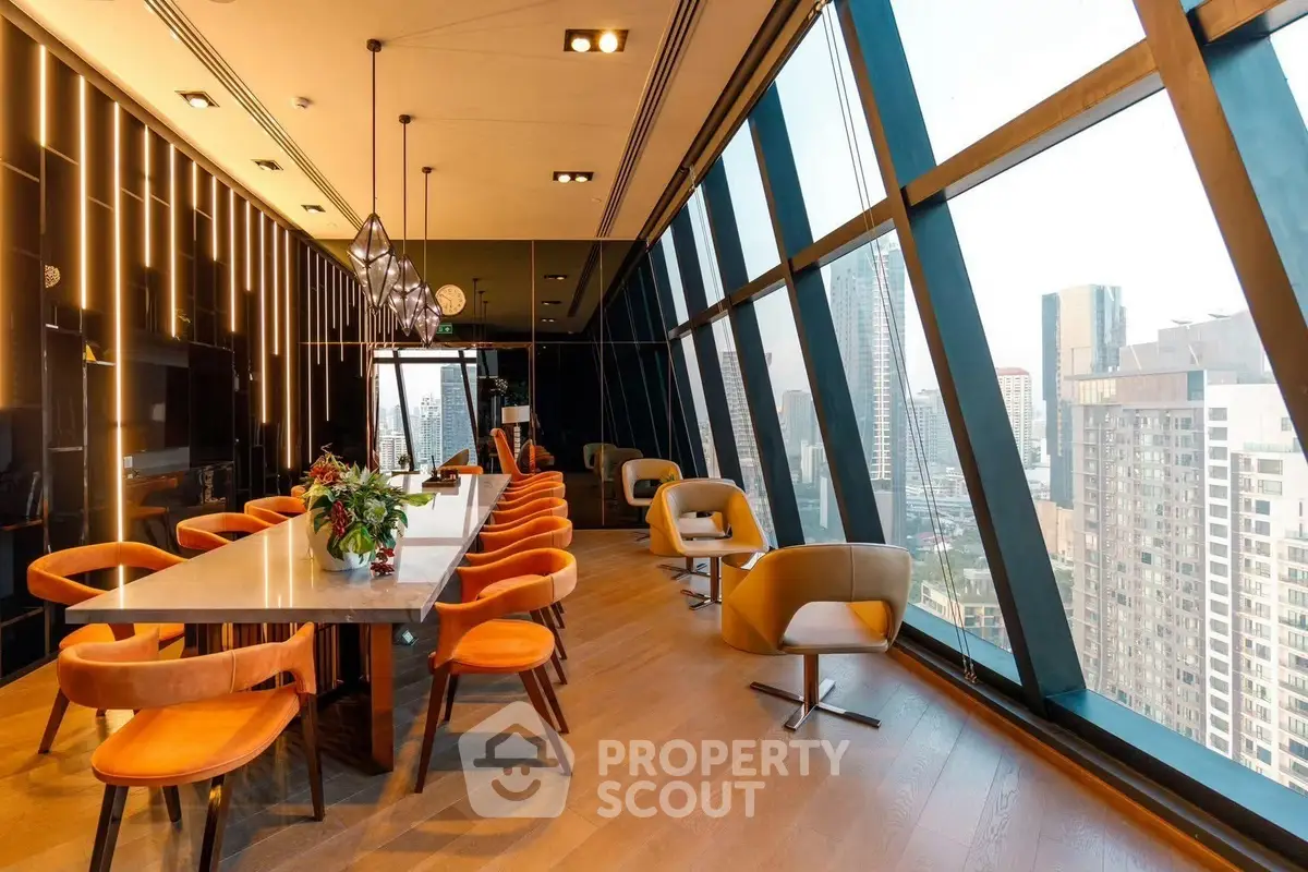 Luxurious modern living room with panoramic city views and stylish furnishings in a high-rise building.