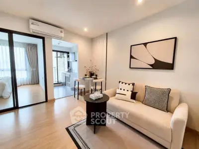 Modern living room with cozy sofa and stylish decor in open-plan apartment
