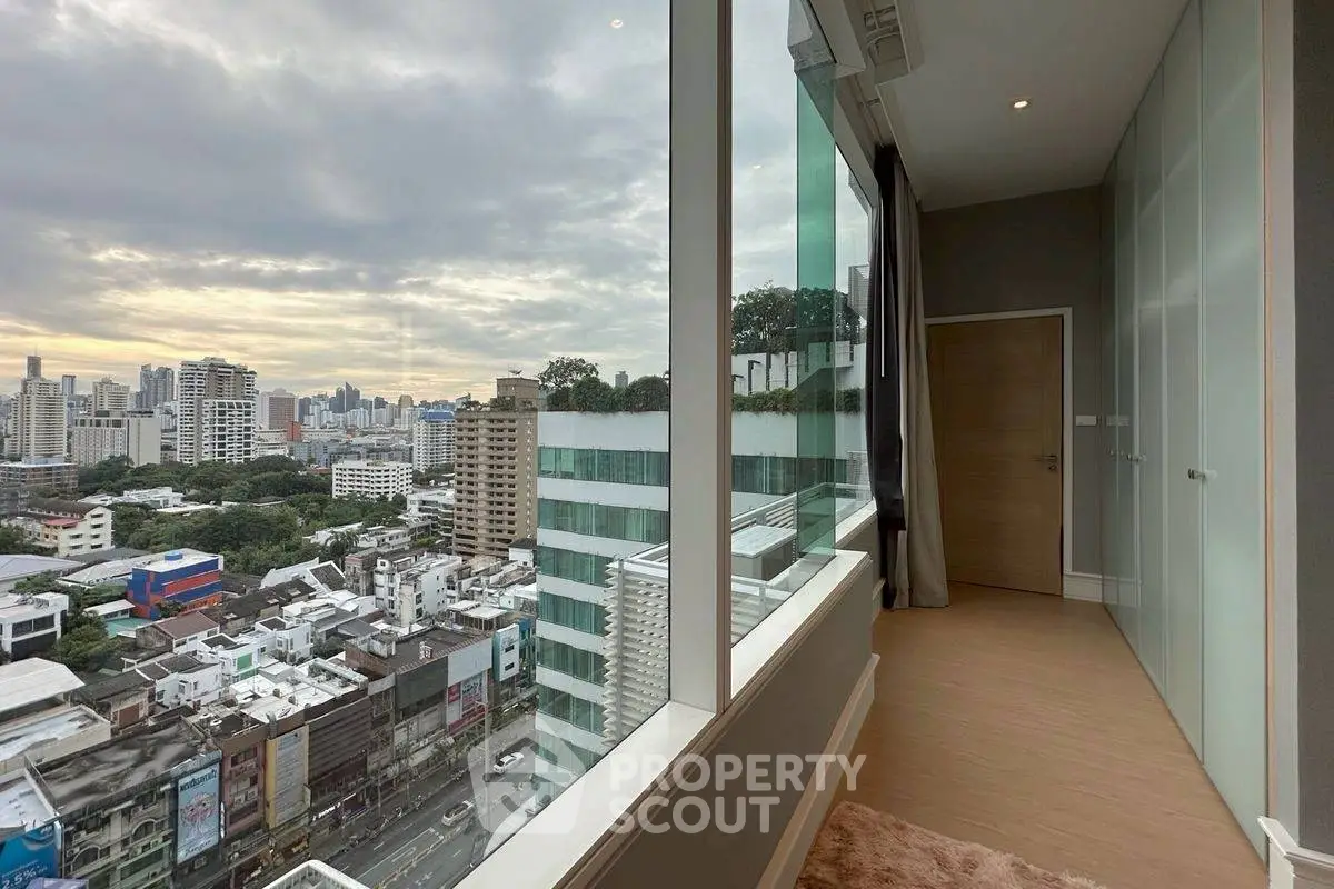 Stunning city view from modern high-rise apartment with floor-to-ceiling windows