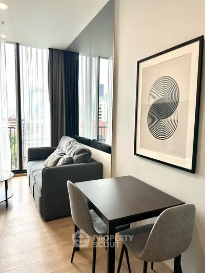 Modern living room with stylish decor and large windows offering city views.