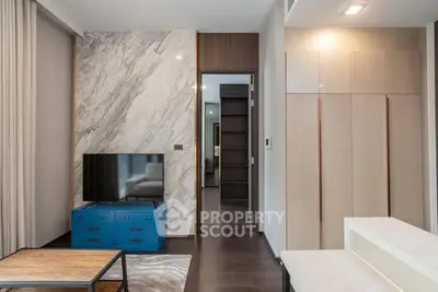 Modern living room with marble accent wall and sleek cabinetry