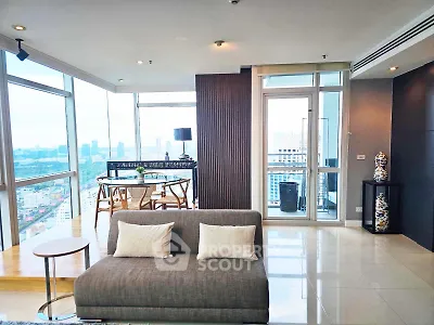 Luxurious high-rise living room with panoramic city views and modern decor.