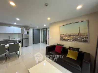 Modern open-plan living room with sleek kitchen and stylish decor