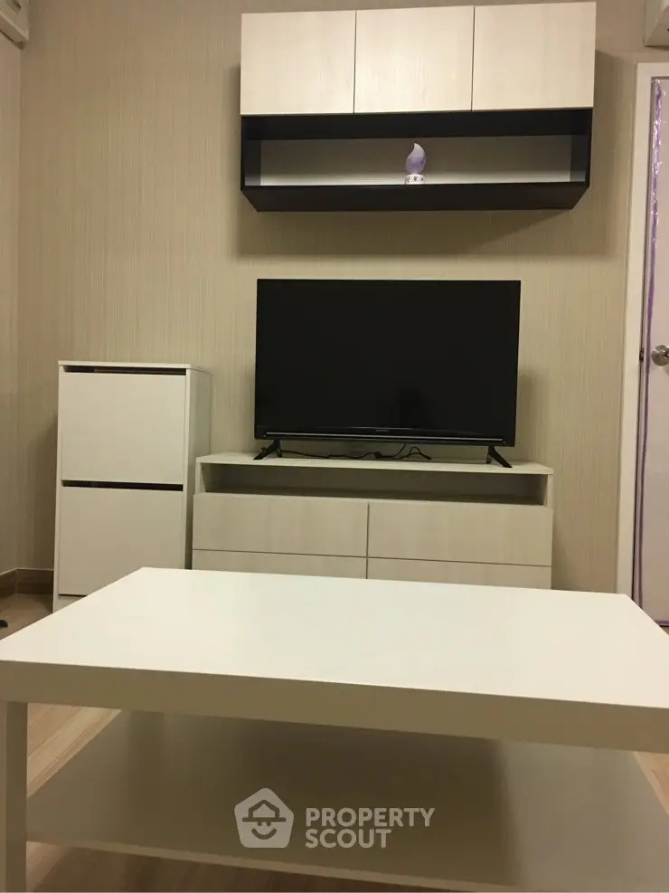 Modern living room with sleek furniture and flat-screen TV, perfect for cozy relaxation.