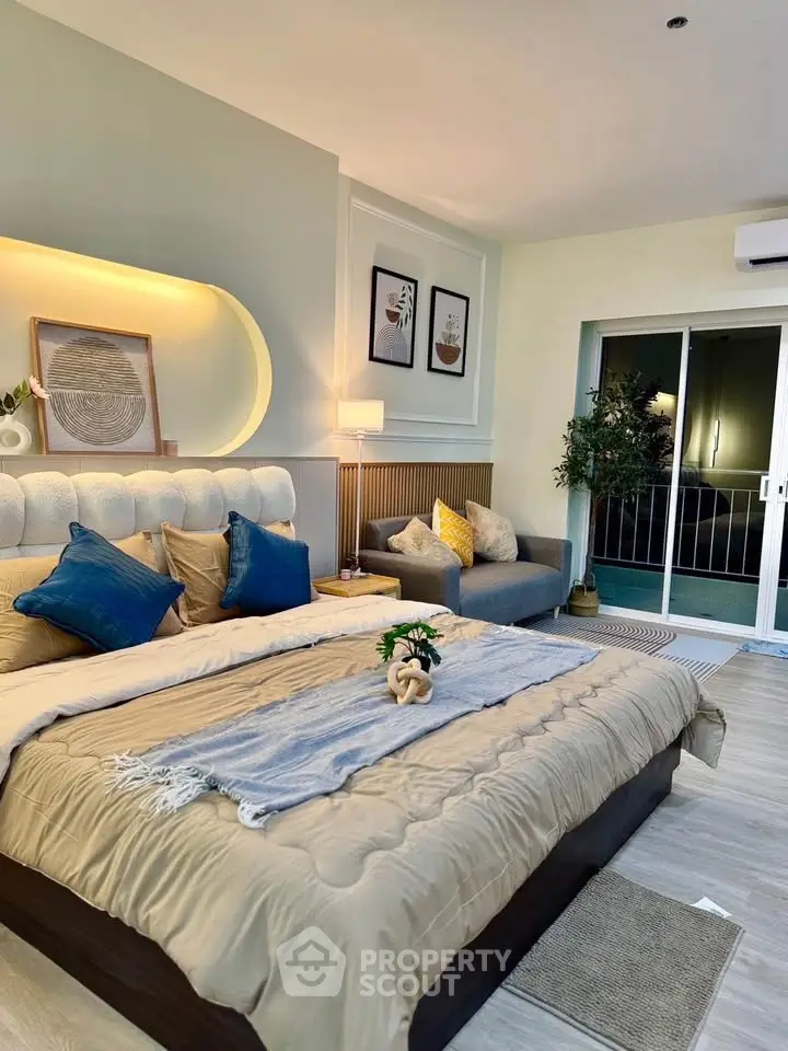 Luxurious bedroom with elegant decor and cozy seating area, perfect for relaxation.