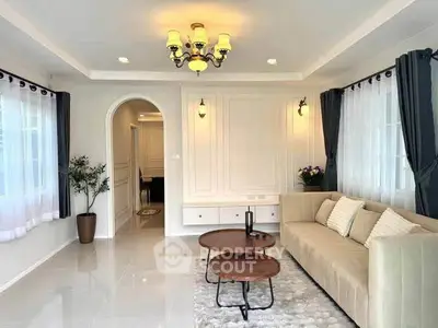 Elegant living room with plush sofa, stylish lighting, and large windows for natural light.