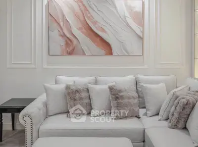Elegant living room with plush gray sofa and abstract wall art