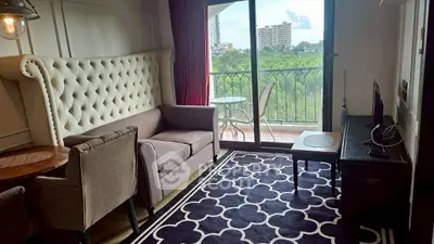 Chic living room with plush seating and balcony view in modern apartment.