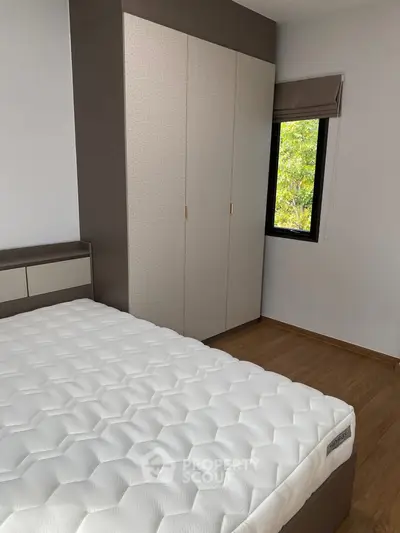 Modern bedroom with large wardrobe and comfortable mattress