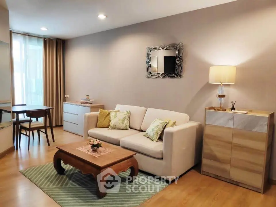 Chic and cozy living room with modern decor and ample natural light, perfect for relaxation and entertaining.