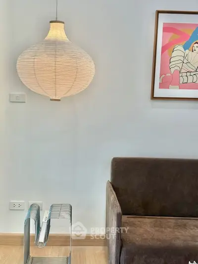 Stylish modern living room with unique lighting and contemporary art decor.