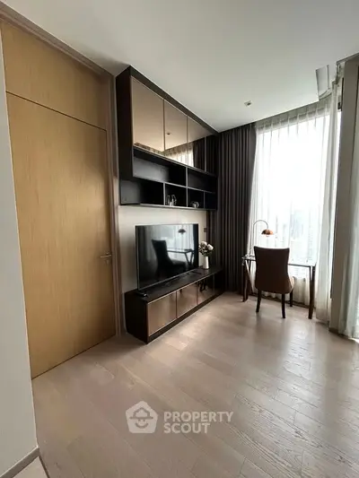 Modern living room with sleek TV unit and stylish study corner, featuring floor-to-ceiling windows for natural light.