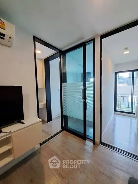 Modern apartment interior with sliding glass doors and balcony view