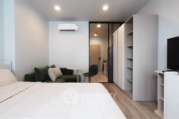 Modern bedroom with cozy seating area and sleek design