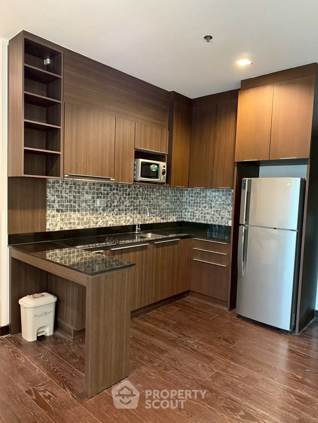 Modern kitchen with sleek wooden cabinets and stainless steel appliances