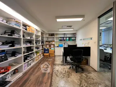 Modern office space with open shelving and sleek desk in a professional setting.