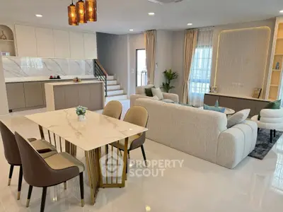 Luxurious open-plan living room with modern kitchen and elegant dining area.