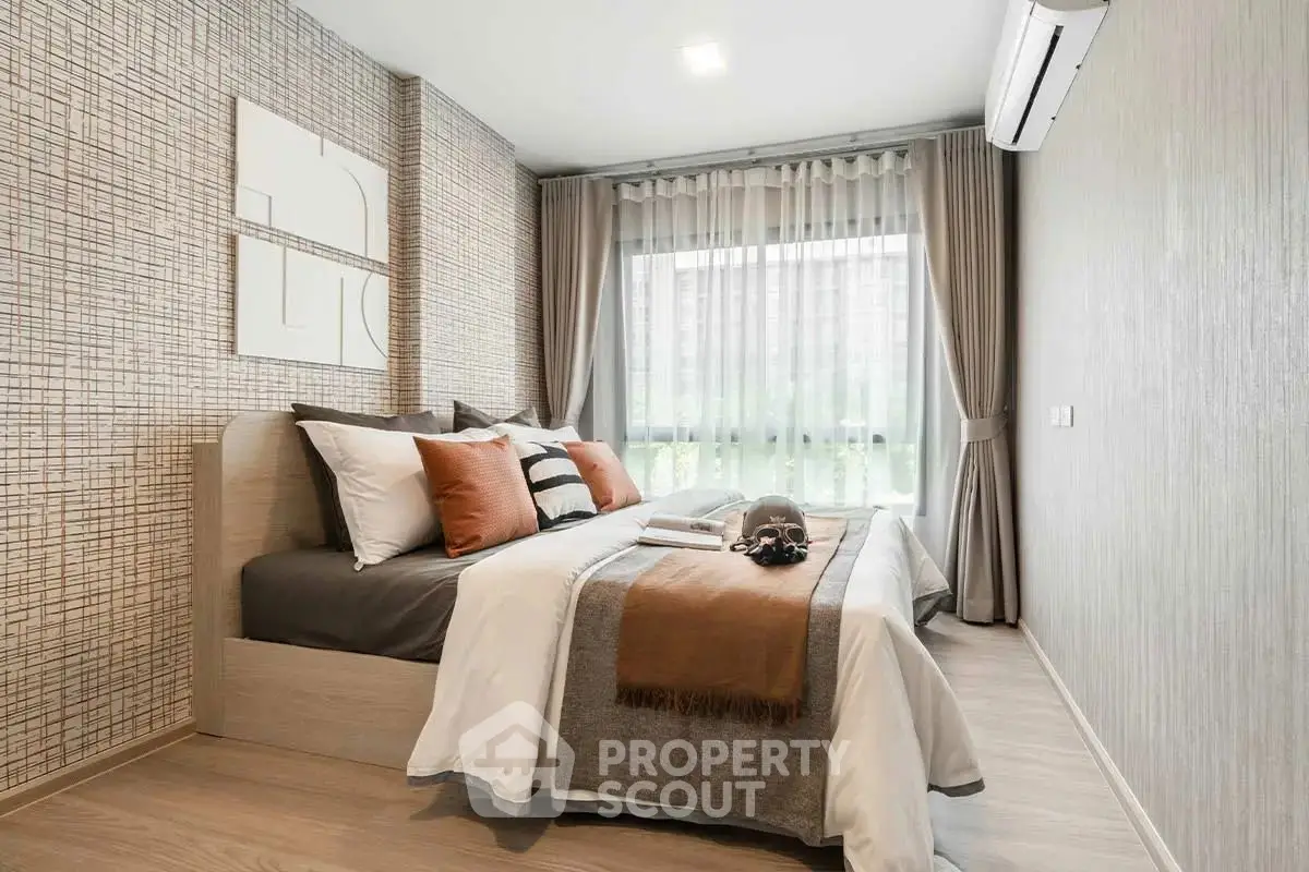 Modern bedroom with stylish decor and large window for natural light.