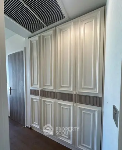 Elegant hallway with built-in storage cabinets and modern design
