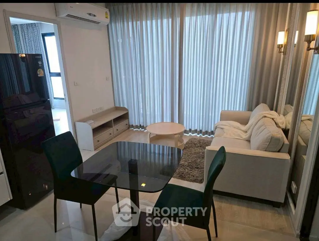 Modern living room with elegant furniture and large windows in a stylish apartment.