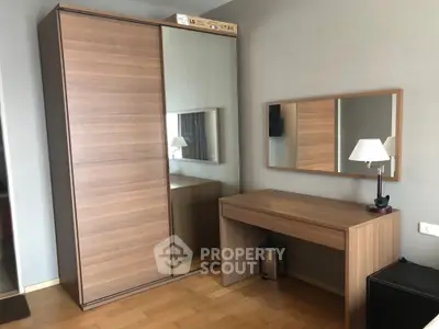Modern bedroom with wooden wardrobe and sleek dressing table, perfect for stylish living.