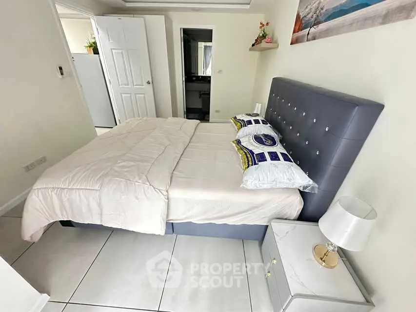 Modern bedroom with stylish bed and elegant decor in a cozy apartment.