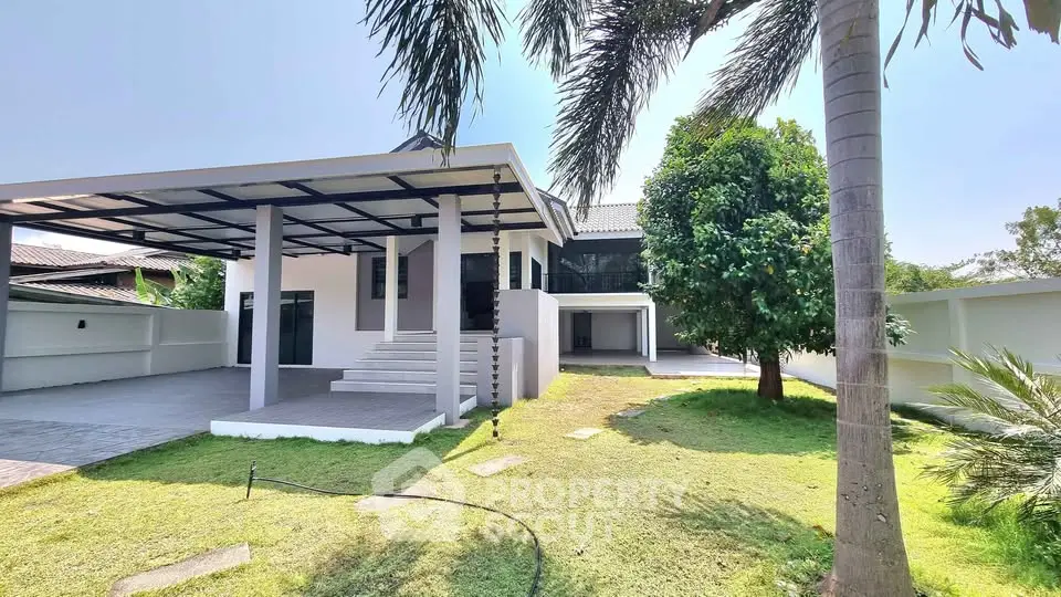 Spacious modern home with lush garden and covered patio in serene neighborhood.