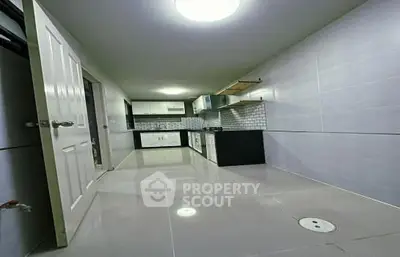 Modern kitchen with sleek cabinetry and tiled backsplash in a spacious layout.