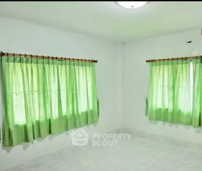 Bright empty room with green curtains and white walls, ideal for customization.