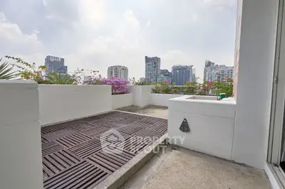 Stunning rooftop terrace with city skyline views and lush greenery