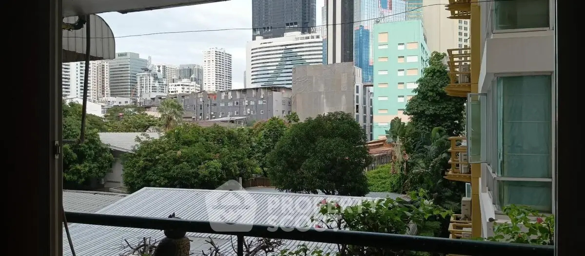 Stunning urban view from balcony overlooking city skyline and lush greenery