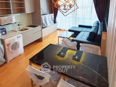 Modern living room with stylish furniture and large windows offering city views.