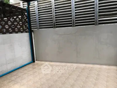 Spacious outdoor patio with privacy fence and tiled flooring