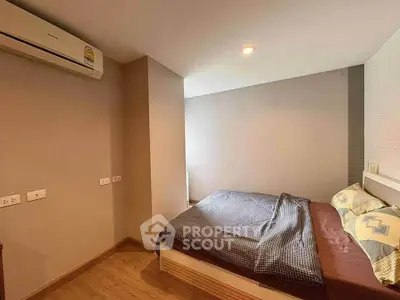Cozy bedroom with modern air conditioning and stylish bedding in a contemporary apartment.
