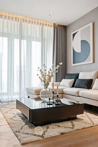 Elegant living room with modern decor, large windows, and stylish furniture.