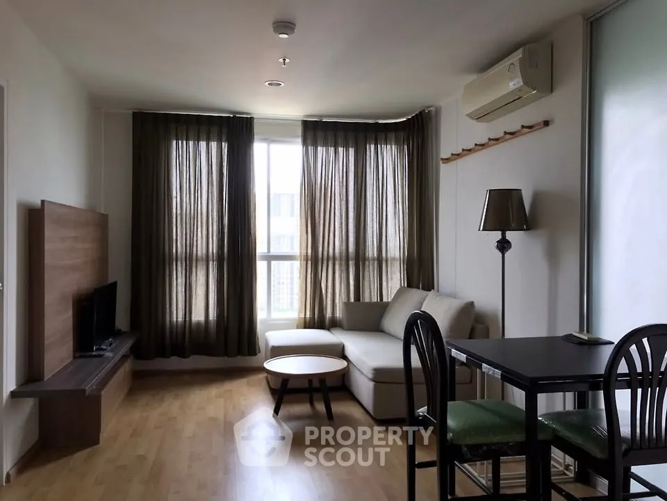 Modern living room with natural light, cozy sofa, and stylish decor in a contemporary apartment.