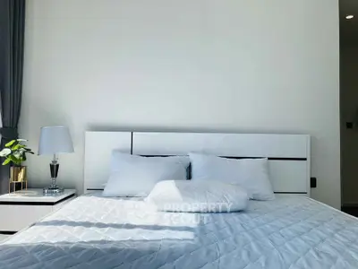 Modern bedroom with stylish white bed and elegant decor