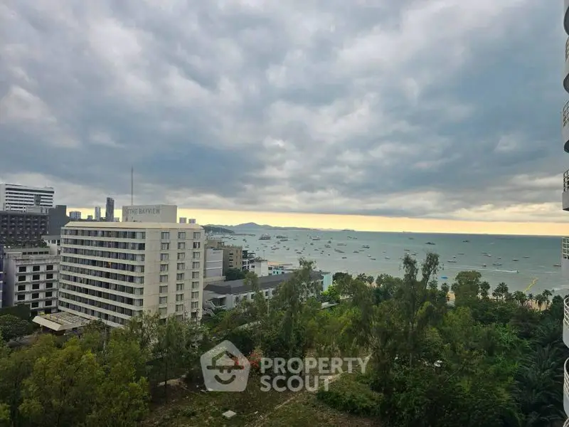 Stunning coastal view from high-rise building overlooking ocean and cityscape.