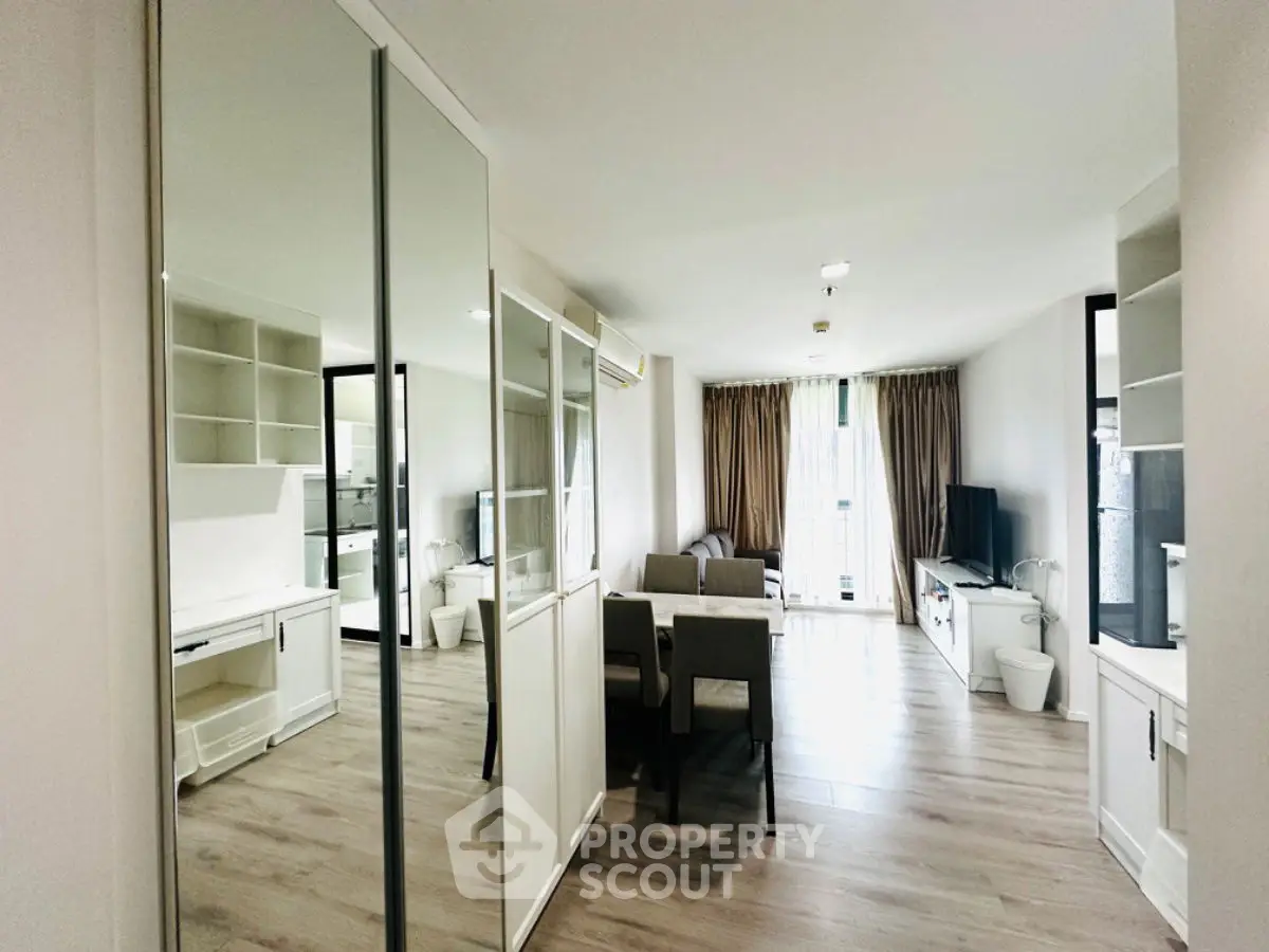 Spacious modern living room with elegant decor and large windows for natural light.