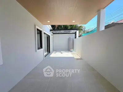 Spacious outdoor patio with modern design and ample natural light, perfect for relaxation and entertainment.