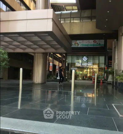 Modern building entrance with sleek design and reflective flooring