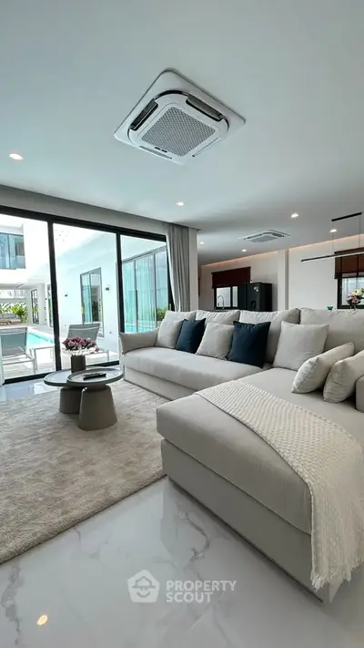 Luxurious modern living room with pool view and elegant decor