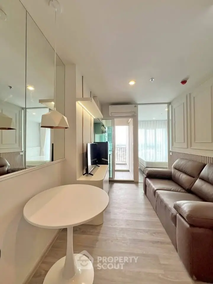 Modern living room with sleek design, leather sofa, and balcony view in a stylish apartment.