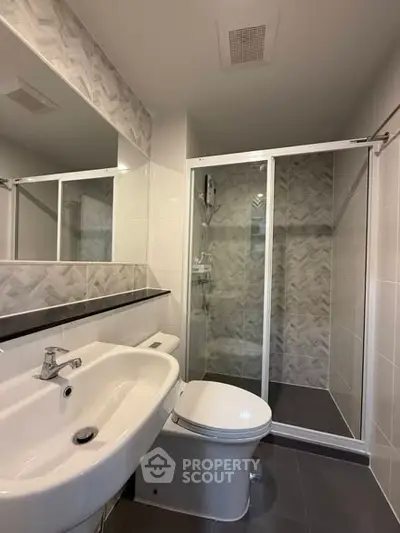Modern bathroom with sleek shower and contemporary fixtures.