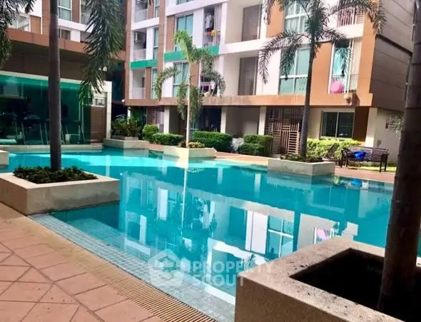 Luxurious apartment complex with stunning pool and modern architecture.